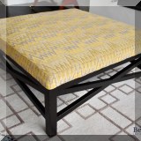 F03. Cocktail ottoman with gray and gold geometric pattern upholstery. 18”h x 42”w x 42”d 